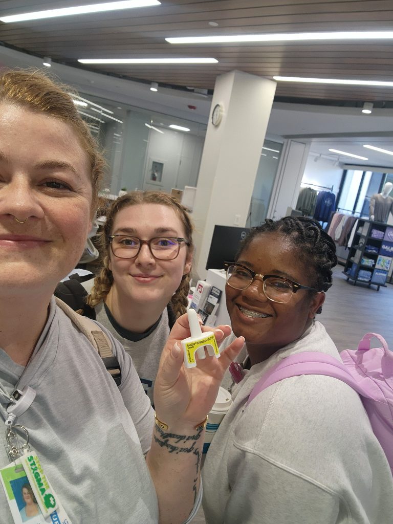 Galen students hold a naloxone device during opioid overdose response training.
