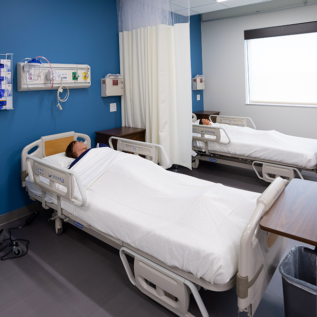 Galen Austin simulation lab with 2 medical mannequins on hospital beds.