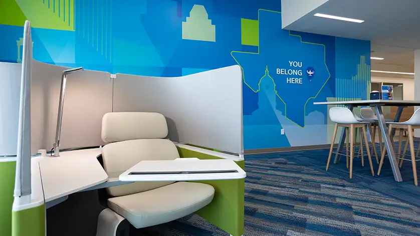 Galen Austin campus commons areas with blue wall mural that shows a map of Texas and reads You Belong Here.