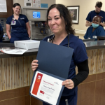 Shannah Flores displays her flower bud award.