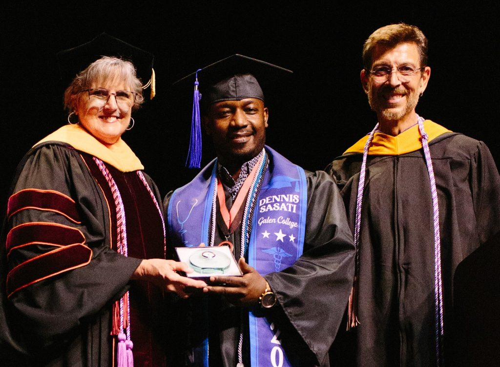 Asheville Dean Lorraine Geffon, Sasati, and Asheville faculty member Robert Credeur at graduation.