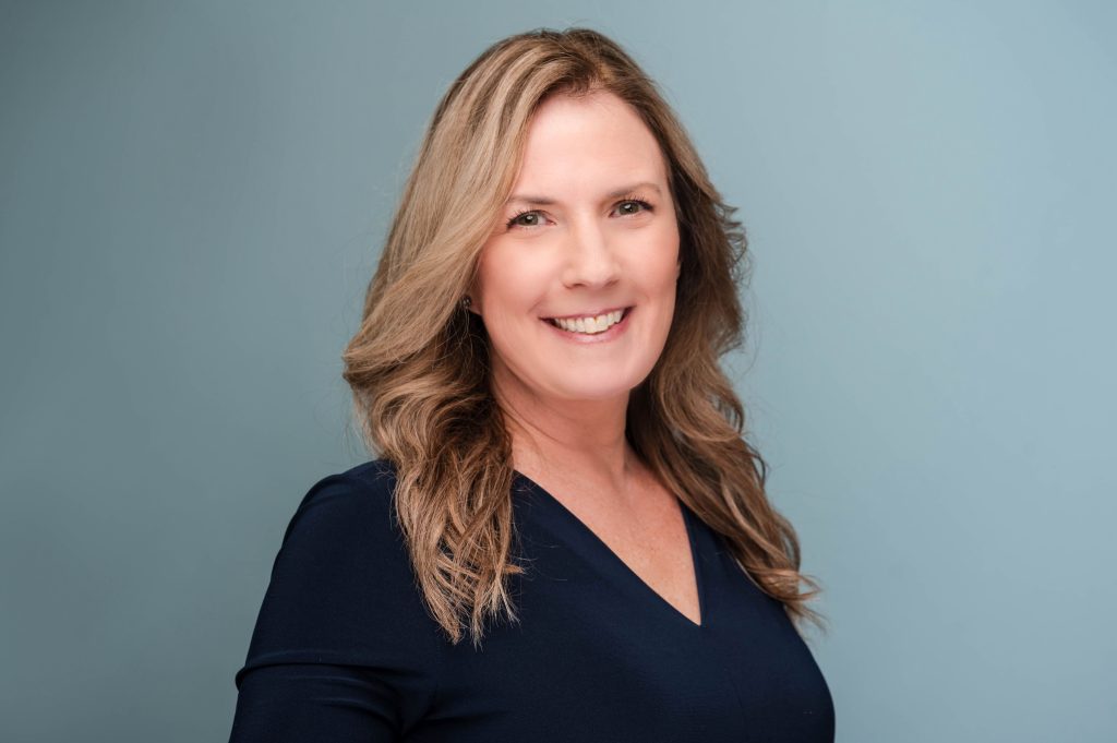 A woman smiles for a photo.