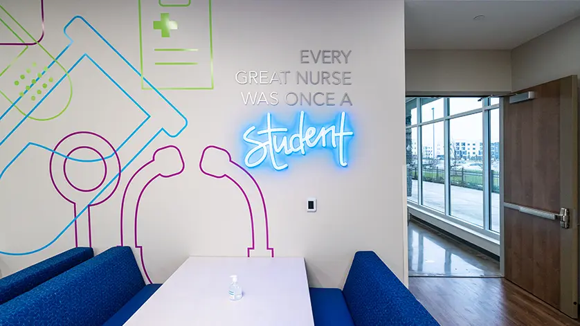 Student commons area in Galen Louisville campus. Wall reads Every great nurse was once a student.