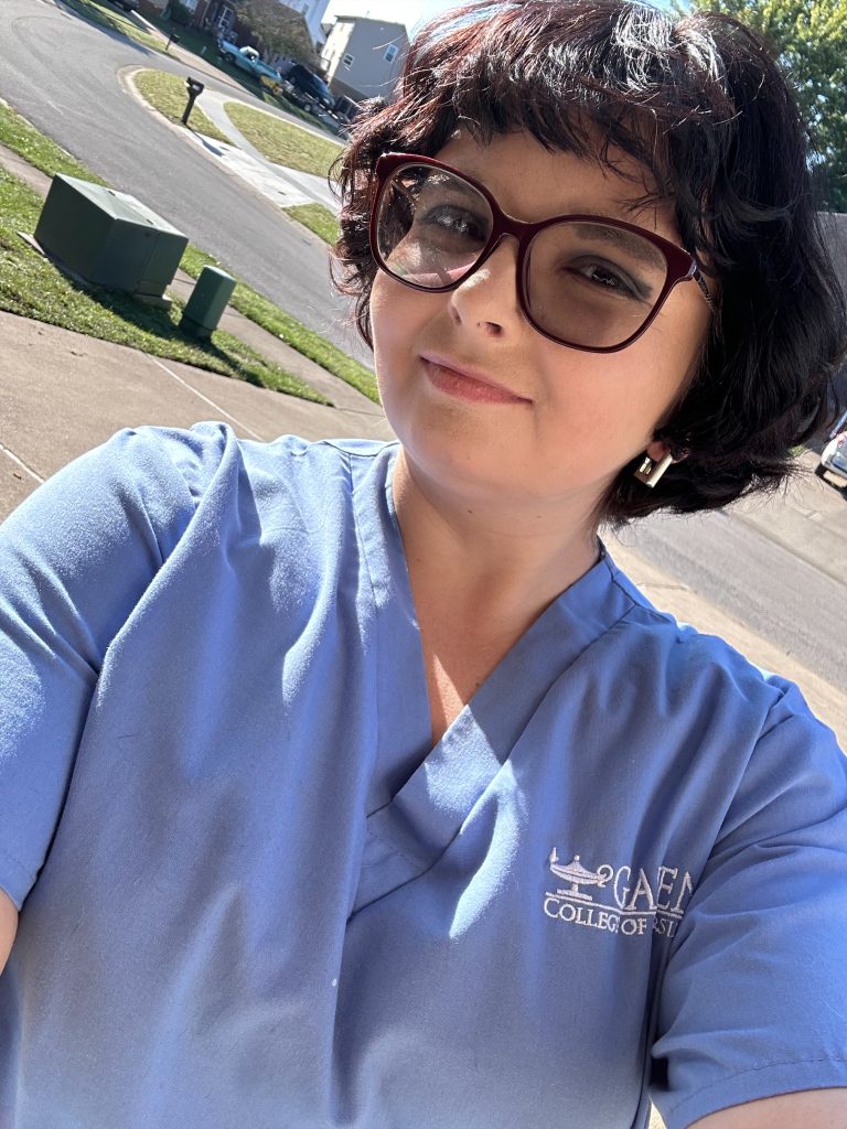 A person takes a selfie in front of the street. 