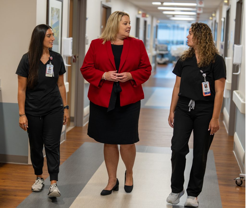 Dr. Sammie Mosier (center) visits with HCA Healthcare 