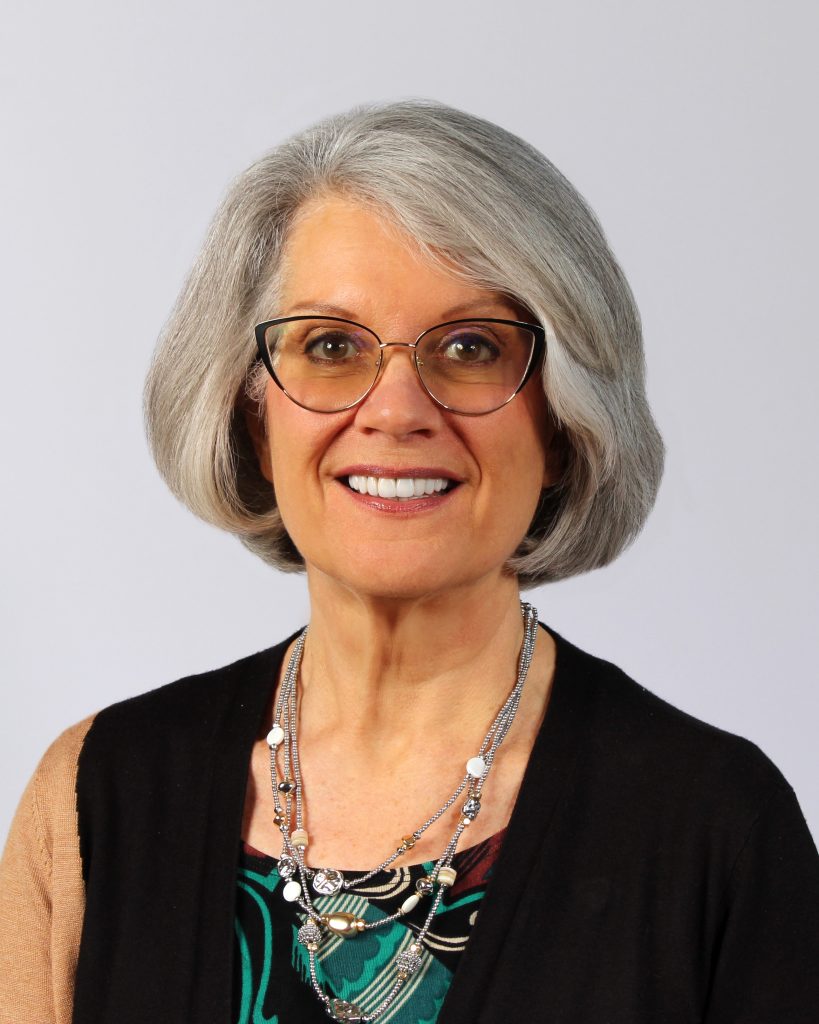 A woman smiles for a photo