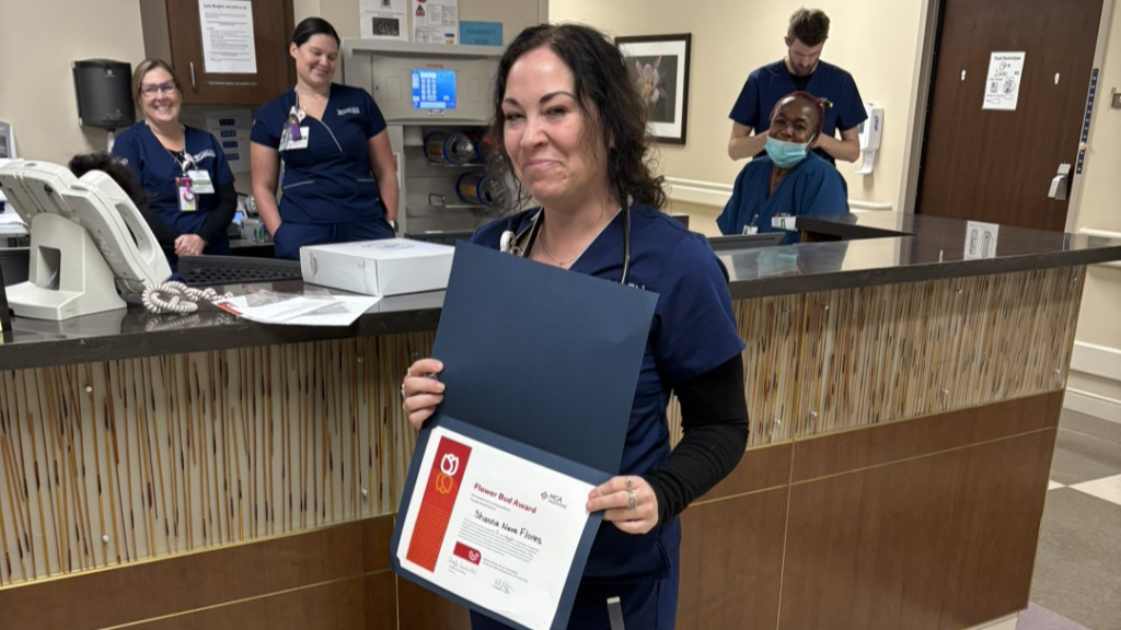 Shannah Flores displays her Flower Bud Award.