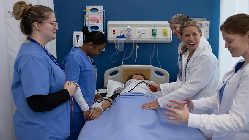 Galen nursing instructors and students gathered around a 